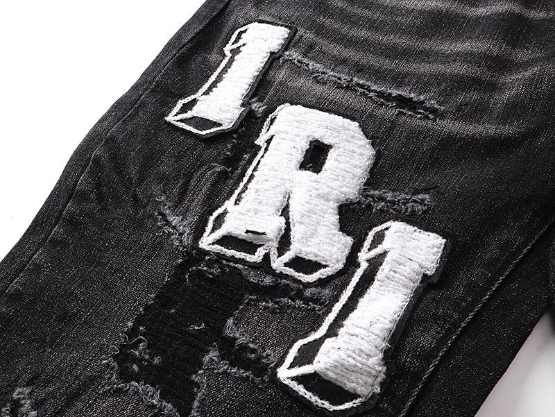 AMIRI Varsity Letter Appliqu¨¦ Distressed Jeans ¡ª detail